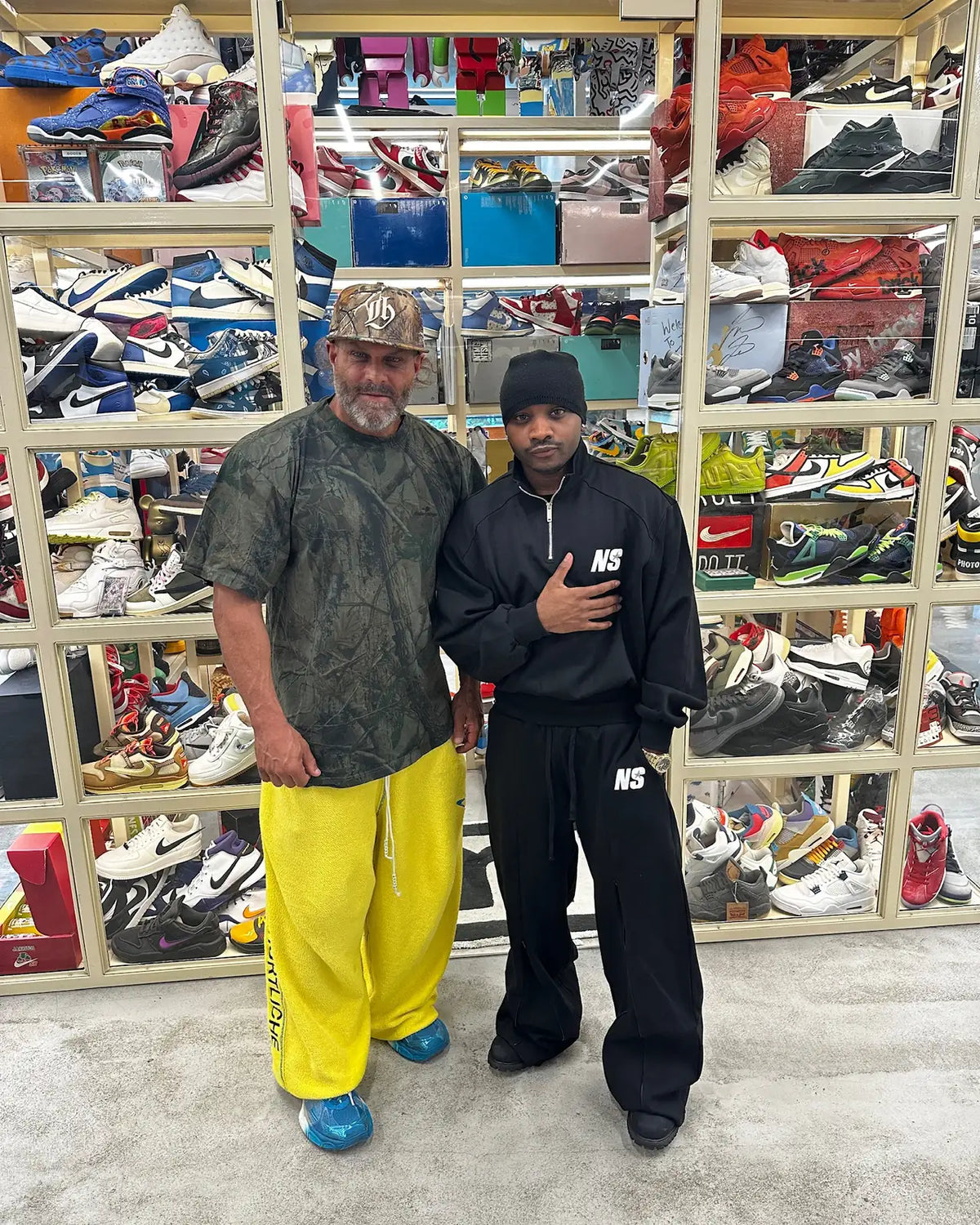 Two customers in front of the sneaker shelving at Immense Galerie Royalmount