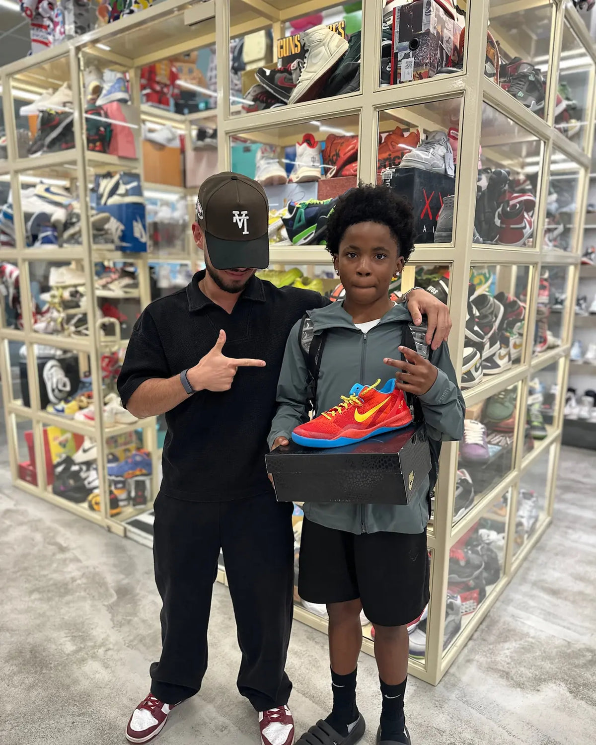 Customer and a young shopper with a Nike Kobe shoe box at Immense Galerie
